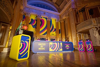 stage in concert room at st george’s hall, dressed with eurovision tables and branding