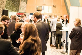 A group of people networking at an industry conference.