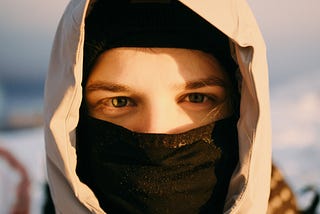 White man’s face covered with balaclava