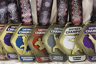 A collection of Zack’s Taekwondo competition medals