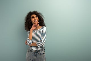 Image of woman standing with blue-grey background