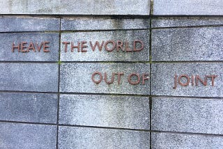 Image shows the wording which sits underneath the sculpture of the head on the Salford University Campus.