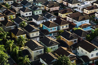 A grid of suburban houses with different house paint. Some are blue, yellow, brown, etc.