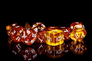 amber-colored dice on a black background
