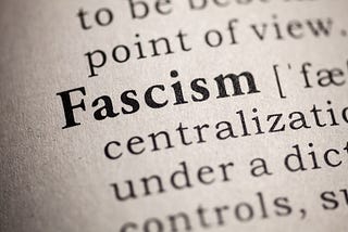 Close up view of a dictionary definition of fascism with the word Fascism capitalized