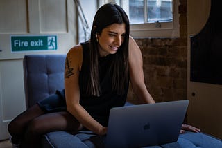 Community entrepreneur on bed with laptop