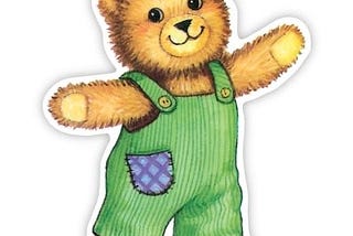 Corduroy the bear wearing green corduroy overalls with a blue patched pocket sewn onto them.