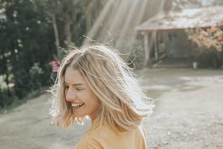 A girl laughing sunlight hitting her face.