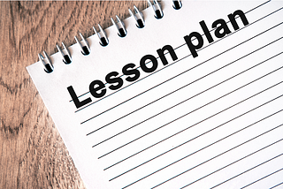 a spiral note pad used for writing a lesson plan