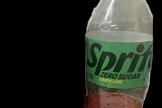 Bottle of Sprite Zero Sugar with red liquid in the bottom 25 percent of the bottle.