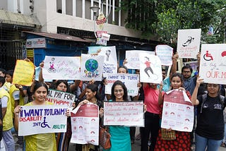 People holding placards at a disability rights protest.