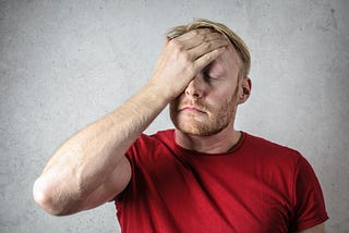 tall man in red tshirt worried about shopping — ilovetall.com