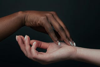 One black and one white hand on top of each other