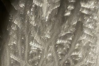 Frozen ice trails on the roof of a conservatory — photo taken at night.