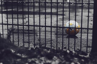 Abandoned soccer ball in empty schoolyard