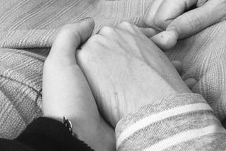 holding my mom’s hand for reassurance