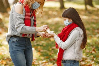A mother with her daughter doing philanthropy work.