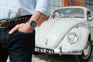 Pocket shot of the Omega Speedmaster with Bruno’s Volkswagen Beetle on the background