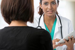Woman talking with a female doctor.