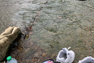 a picture of me sitting on a rock along hurricane creek.