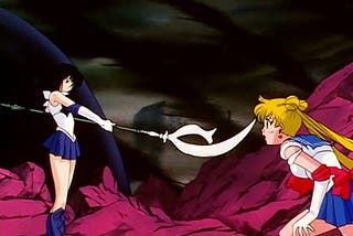 A photo of Sailor Saturn pointing her weapon, the Silence Glaive at Sailor Moon before she goes to destroy Pharaoh 90 in Sailor Moon S