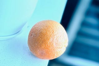 Orange at the edge of a counter