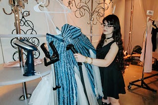 Inas steams one of her dresses backstage before it is shown at Omaha Fashion Week