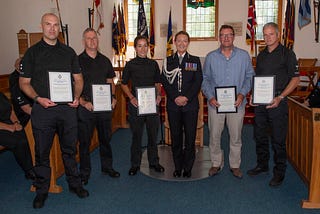 MDP Chief Constable Melanie Dales standing with the winners of the Team Excellence Award at the award ceremony at Southwick Park