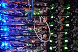 A rack of computers cabled together with blinking lights.
