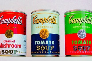 three vintage bright cans of Campbell’s soup from Andy Warhol