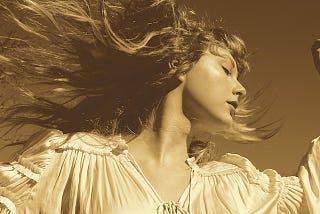 Album cover: Fearless (Taylor’s Version)- 2021 release. A photograph of Taylor Swift, with her hair moving in the wind.
