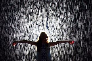 Woman standing under the downpour