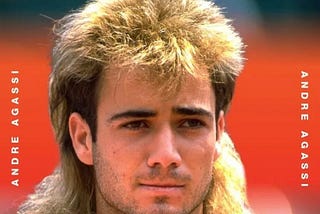 Young Andre Agassi with his mullet hair in front of a red background