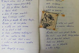 Two pages covered in angular handwriting with a little glued illustration of a woman holding wild flowers.