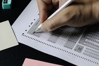 A person bubbles in answers on a standardized test.