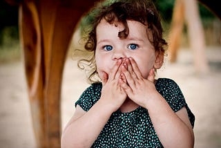 Toddler blowing a big kiss.