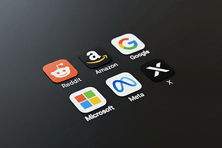 Social media and tech company app icons, including Reddit, Amazon, Google, Meta, Microsoft, and X, are arranged on a dark surface.