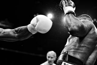 Black and white image of boxers in the ring.