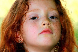 young girl looking defiant