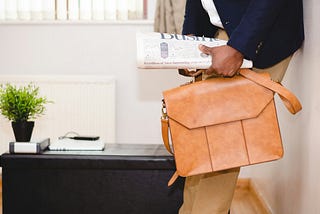 Someone going to work and holding business newspapers (Image is only for esthetism and not related to the article)