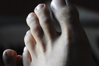 A close-up of a man’s toes.