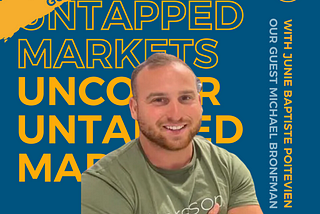 Michael is a White Man smiling with arms crossed. He is wearing a green shirt with the name baresop on it. Behind Michael, there is a navy blue background with the podcast title juxtaposed one on top of the other. It says Uncover Untapped Markets in bold yellow at the top and regular yellow font at the bottom. On the right-hand side it says: with Junie Baptiste Poitevien, who is the podcast host. Underneath it, it says: our podcast guest Michael Bronfman.