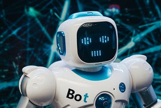 The upper body of a white robot with a “Bot” name on its chest