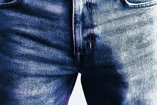 Shot of a man wearing jeans. We can only see the crotch area and an outline of a penis.