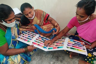 Women confirm yarn colors at a training focused on quality control organized by Chitrika in Narayanpet.