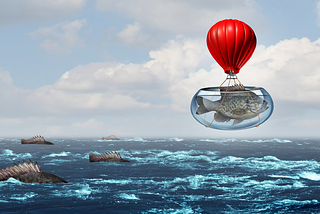 Fish in a fish bowl above the ocean