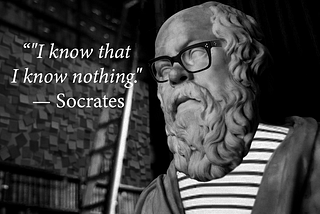 Socrates statue wearing glasses, a t-shirt and quoting ‘I know that I know nothing’