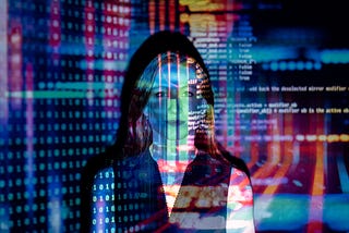 woman standing in front of projection of code on a screen