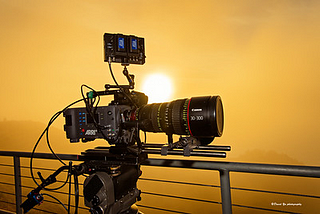 A video camera with a sunset in the background.