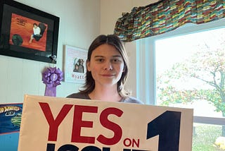 Wyatt Tomlin holding a Ohio vote yes on Issue 1 sign